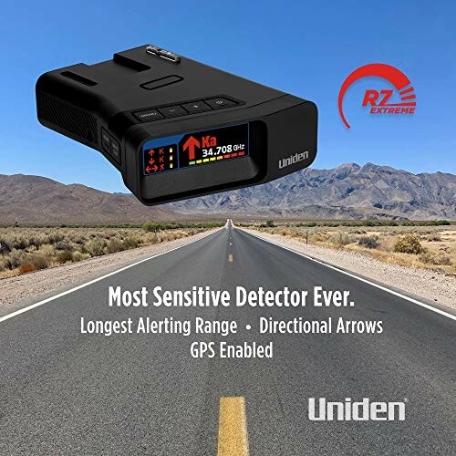 Uniden R7 radar detector on a highway with mountains in the background.